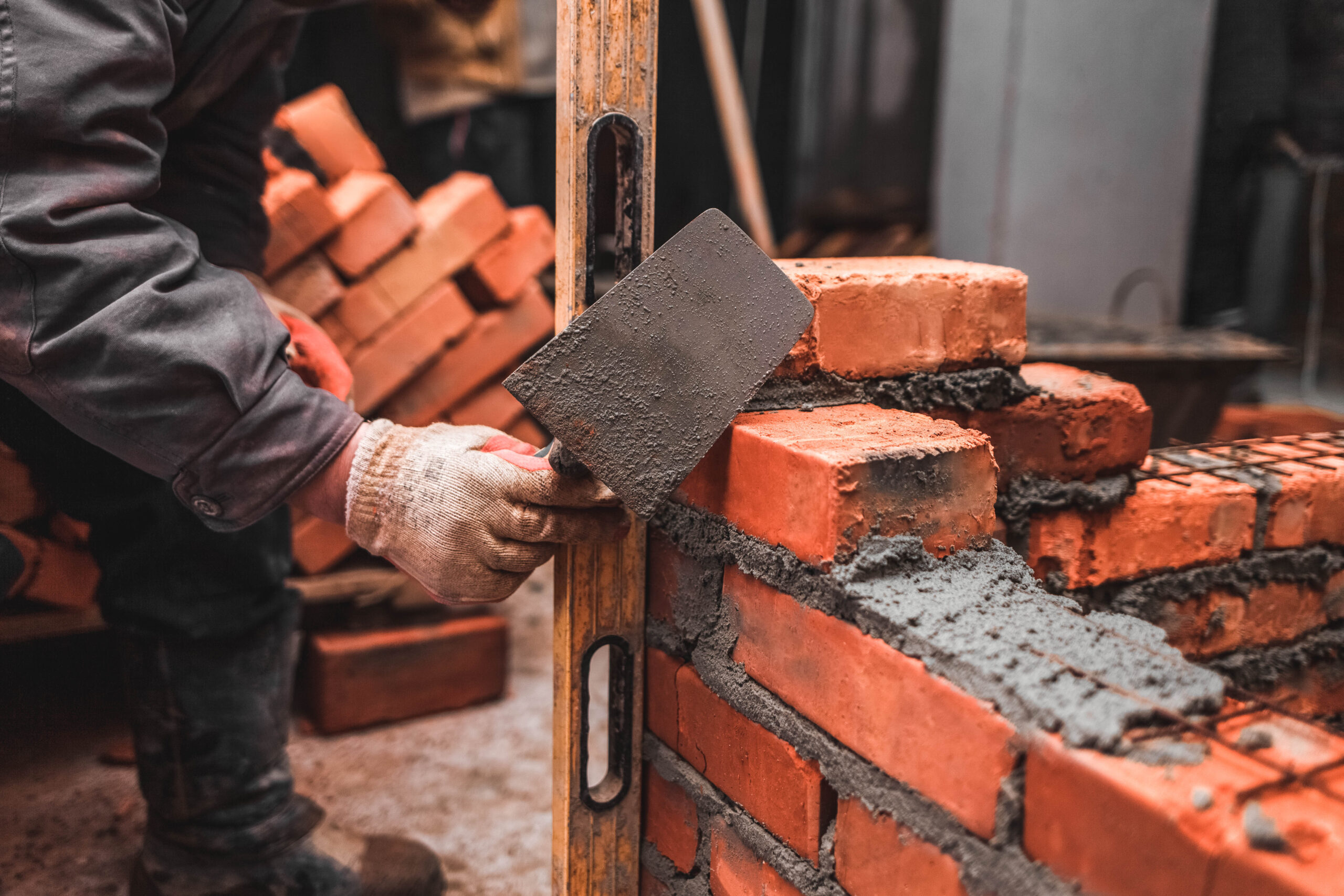 Close-up of a new load-bearing brick wall being constructed, showcasing precision masonry and high-quality structural brickwork by Greenview Construction.