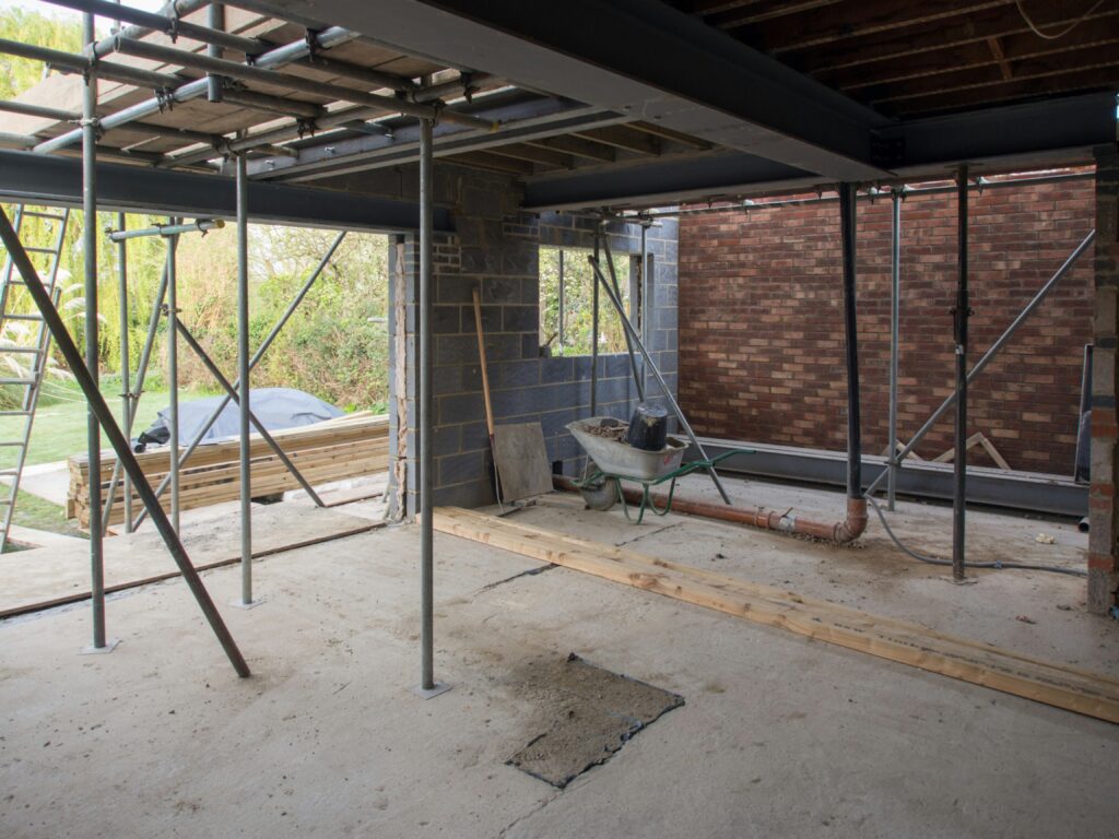 Professional scaffolding setup for a multi-story building renovation, highlighting Greenview Construction’s commitment to site safety and exterior structural repairs.